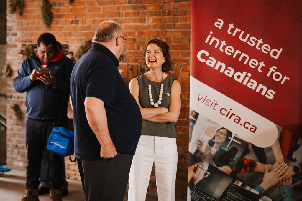 A CIRA member laughing with a guest at the event