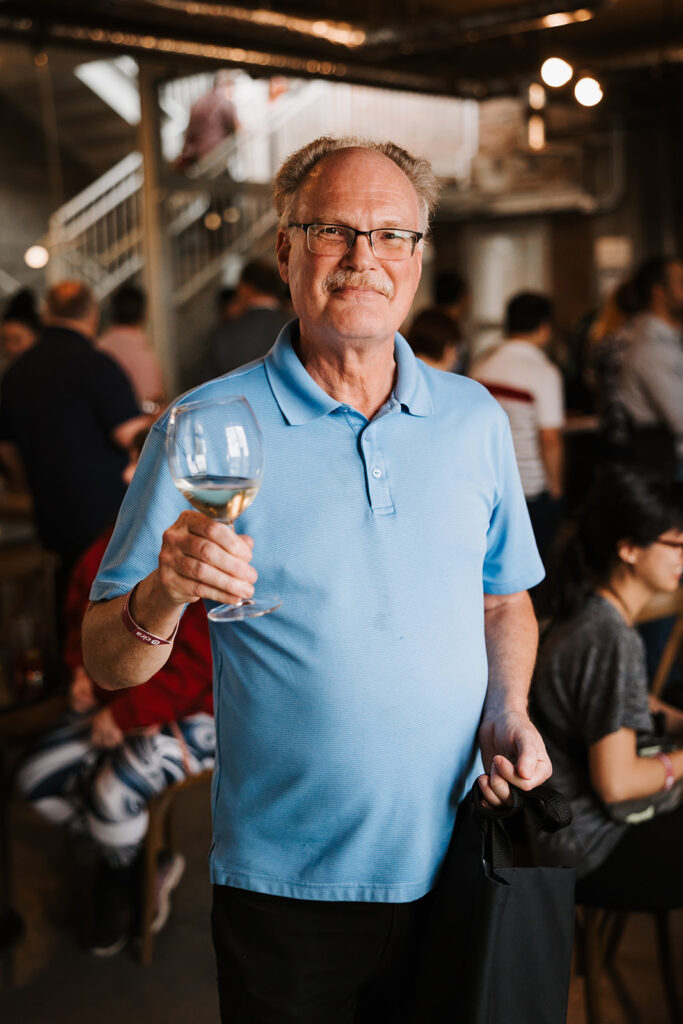 An attendee enjoying the complimentary drinks